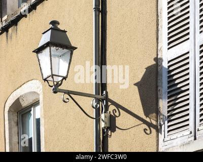 Light and shade - street lamp with shadow on house wall - Le Blanc, Indre (36), France. Stock Photo