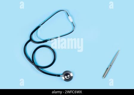 Stethoscope on light blue background, top view. Space for text. Stock Photo