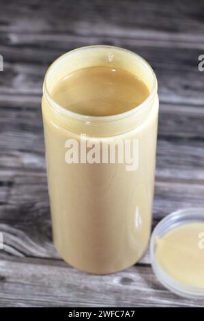 Tahini Tahina which is a Middle Eastern condiment made from toasted ground hulled sesame, served by itself (as a dip) or as a major ingredient in humm Stock Photo