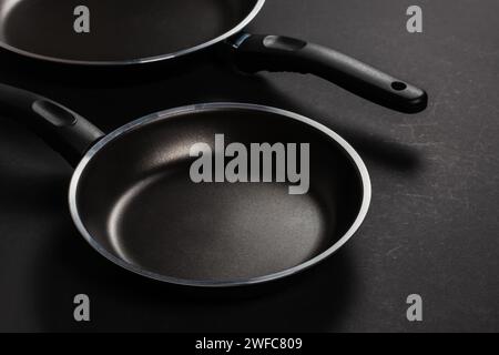 Two black frying pan on dark background, close-up Stock Photo
