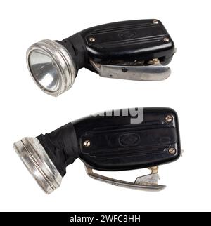 Old mechanical dynamo flashlight covered with scratches and dust is isolated on a white background. Stock Photo