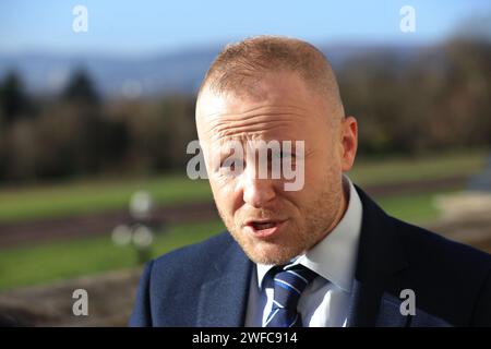 Jamie Bryson, a loyalist activist and vocal opponent of the Government deal speaks to the media outside the Parliament Buildings in Stormont, Belfast, as powersharing in Northern Ireland is set to return after the DUP party executive backed a Government deal aimed at addressing its concerns over post-Brexit trade barriers. Picture date: Tuesday January 30, 2024. Stock Photo