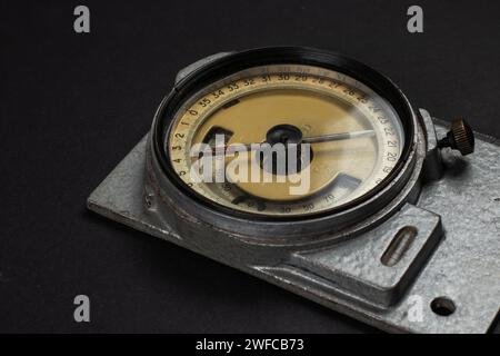 Old mining compass on dark background close up. Stock Photo