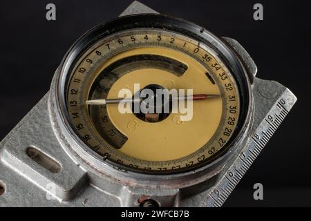 Old mining compass on dark background close up. Stock Photo