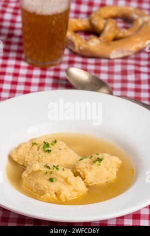 bavarian dumpling soup on tablecloth Stock Photo