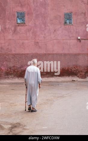 North Africa Morocco Marrakech Marrakesh Moroccan old man in street with traditional costume dress djellaba gallabea jillaba clothing walking stick Stock Photo