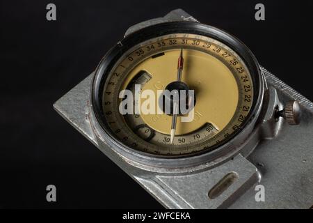 Old geological compass on dark background close up. Stock Photo