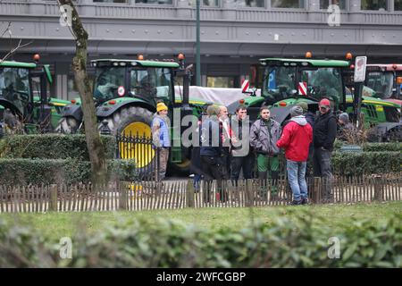 Brussels, Belgium. 30th Jan, 2024. Farmers block a road with their tractors during a protest in Brussels, Belgium, Jan. 30, 2024. Belgian farmers started their protests at the end of last week against decreasing income, increasing regulations and other issues. Credit: Zhao Dingzhe/Xinhua/Alamy Live News Stock Photo
