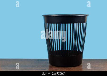 Empty trash, clean garbage bin, plastic basket bin on blue background. Stock Photo