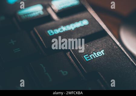 Black shiny keyboard closeup, focus on the Enter key Stock Photo