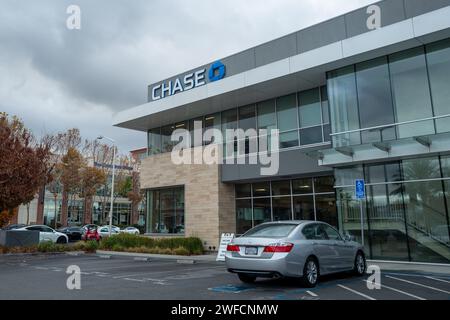 Exterior of Chase bank branch on an overcast day with parking lot in view, San Jose, California, December 2, 2023. Stock Photo