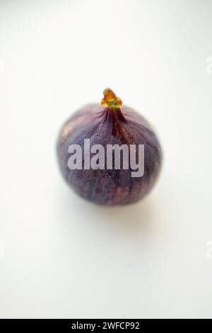 Ripe sweet fig on white blurred table. Selective focus. Stock Photo
