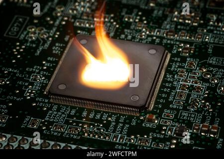 Fire burning micro chip on circuit board with electronic. Stock Photo