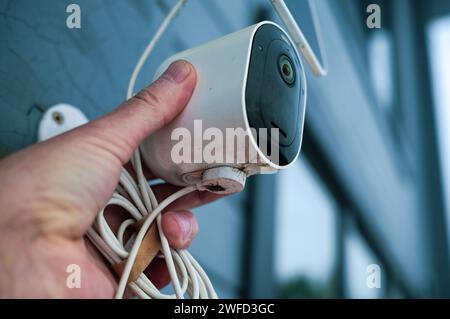 close up of a male hand adjusting surveillance camera Stock Photo