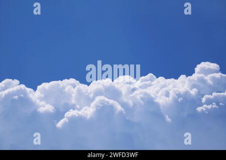 Fluffy White Cumulus Clouds on Vibrant Blue Sunny Sky Stock Photo