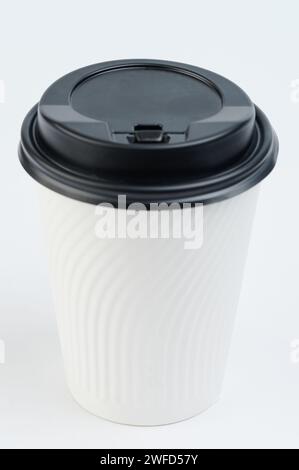 One paper cup mug with black lid isolated on studio background Stock Photo