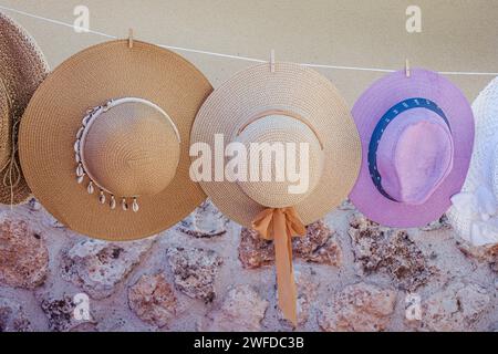 Summer hats hanging from a rope in a street market, Brihuega, Guadalajara, Castilla La Mancha, Spain Stock Photo