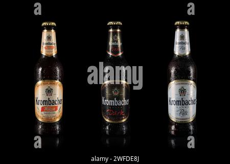 Dnipro, Ukraine, 18 oct, 2023: Bottles Krombacher wheat beer with water drops on black background. Weizen Pils Dark beer. Krombacher brewery was found Stock Photo