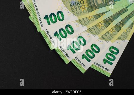 Lot of paper one hundred euro banknotes for bachground. Top view on heap of money. Stock Photo