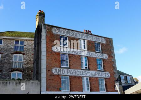 The former London & South Western Railway offices at the Barbican waterfront, Plymouth, Devon, with painted Victorian calligraphy on the brick facade. Stock Photo
