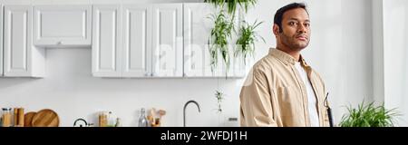 handsome blind indian man in cozy homewear using walking stick while at home, disabled, banner Stock Photo