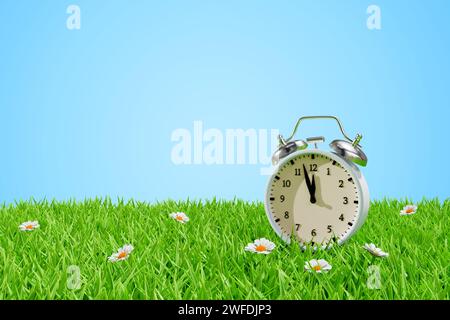 Alarm clock on a meadow in the grass. Daylight saving transitional change of season. 3d rendering Stock Photo