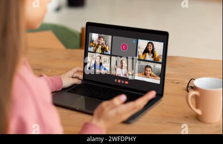 Back view of girl student have online lesson, using laptop Stock Photo