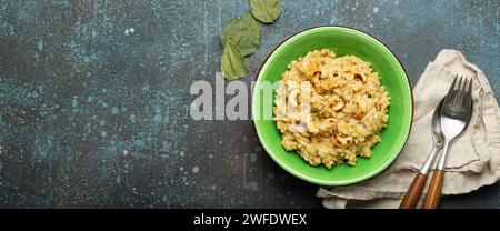 Ven Pongal (Khara Pongal), traditional Indian savoury rice dish made during celebrating Pongal festival, served in bowl top view on concrete rustic Stock Photo