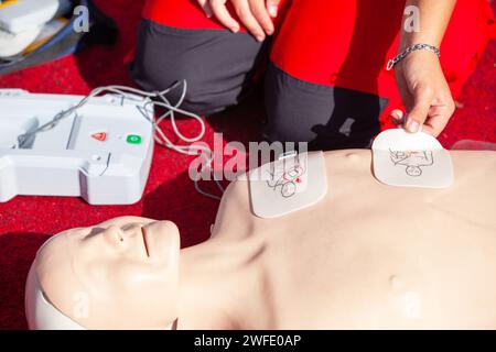 First aid and CPR training using automated external defibrillator device - AED Stock Photo