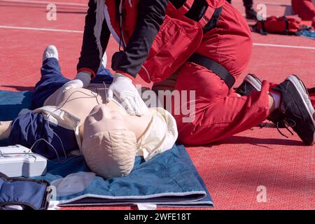 First aid and CPR training using automated external defibrillator device - AED Stock Photo