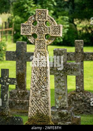 Ornate Carved stone Celtic cross headstone in graveyard of St. James church, Little Dalby, Leicestershire, England, UK. Stock Photo