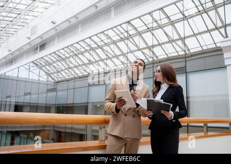 Happy young entrepreneurs smiling while working together in a modern workspace. High quality photo Stock Photo