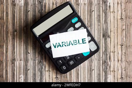 text The variable is written on a sticky note placed on the calculator. Variable universal life insurance. Stock Photo