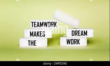 TMDW Teamwork makes the dream work symbol. Conceptual words TMDW Teamwork doing your dream job on a wooden block on a beautiful yellow background. Stock Photo