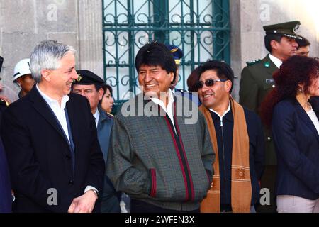 La Paz, BOLIVIA; 24th January 2015. Bolivian president Evo Morales jokes with the vice president Alvaro Garcia Linera (left) at an event outside the Presidential Palace at the start of the Alasitas festival in La Paz. To the right of Evo (wearing a brown scarf) is Cesar Cocarico, the La Paz Department Governor. Stock Photo