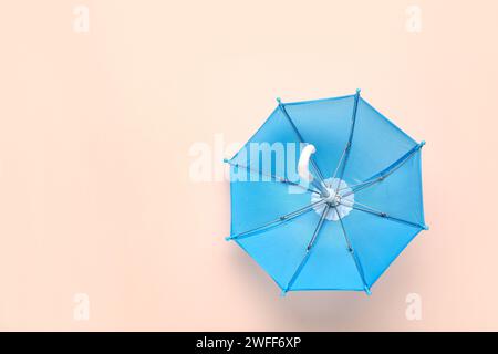 Mini stylish umbrella on beige background Stock Photo