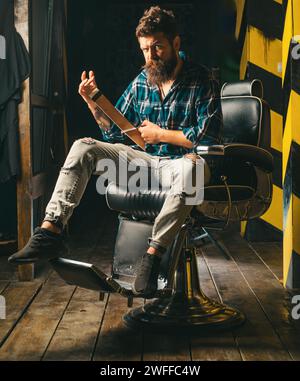 Hair style and hair stylist. Beard styling cut. Barber shop tools on old wooden background with copy space. Bearded man. Stock Photo