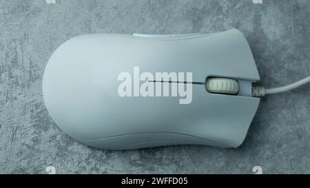 White PC mouse on a gray background with concrete texture Stock Photo