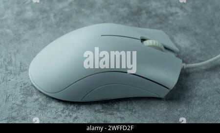 White PC mouse on a gray background with concrete texture Stock Photo