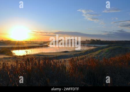 Sunrise in the golf course with mist and birds Stock Photo