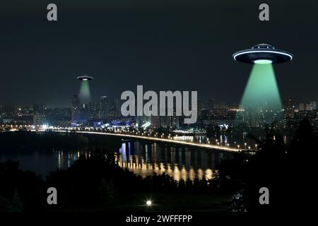 UFO. Alien spaceships emitting light beams over night city Stock Photo