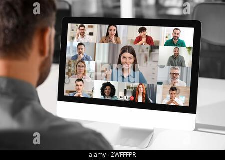 Man having video chat with coworkers at office Stock Photo