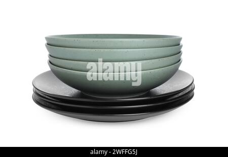 Stack of beautiful ceramic plates and bowls isolated on white Stock Photo