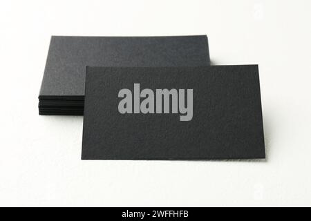 Blank black business cards on white table, closeup Stock Photo