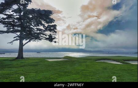 Pebble Beach, USA. 30th Jan, 2024. Pebble Beach, Monterey, California, USA - January 30th 2024 The forerunner of the 'Pineapple Express ' atmospheric river looms over Stillwater Cove and the 18th green two days before the second 'Signature' event of USA PGA Tour season at the famous Pebble Beach Links. Credit: Motofoto/Alamy Live News Stock Photo