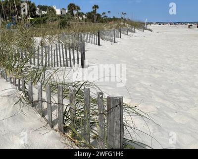 Wood fence along the grassy dunes at the white sand beaches of Sanibel Island Florida USA Stock Photo