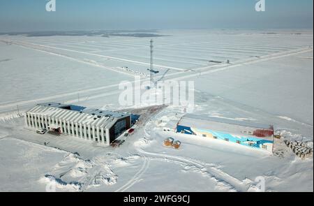 Fuyuan, China's Heilongjiang Province. 30th Jan, 2024. An aerial drone photo shows a cranberry planting base in Fuyuan, northeast China's Heilongjiang Province, Jan. 30, 2024. Fuyuan, a leading hub for large-scale cranberry cultivation in China, boasts a planting area of 4,200 mu (280 hectares). Thanks to greenhouses and new agricultural technologies, fresh cranberries are made available to consumers now despite the freezing weather. Credit: Wang Jianwei/Xinhua/Alamy Live News Stock Photo