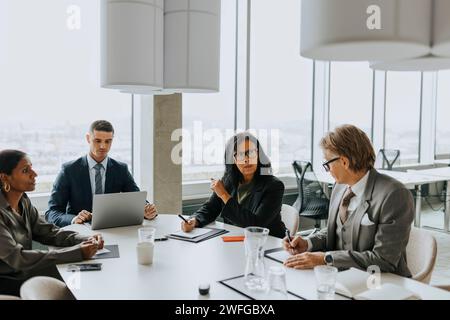 Multiracial business colleagues discussing strategy in board room Stock Photo