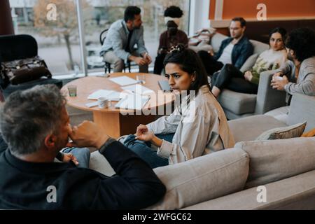 Business colleagues discussing strategy during meeting in office Stock Photo