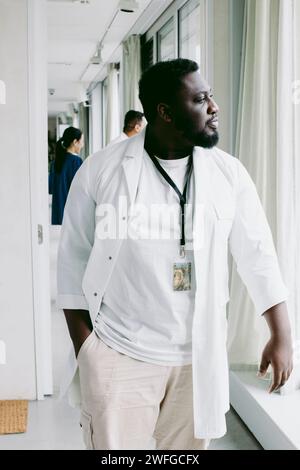 Young male doctor walking at hospital corridor Stock Photo